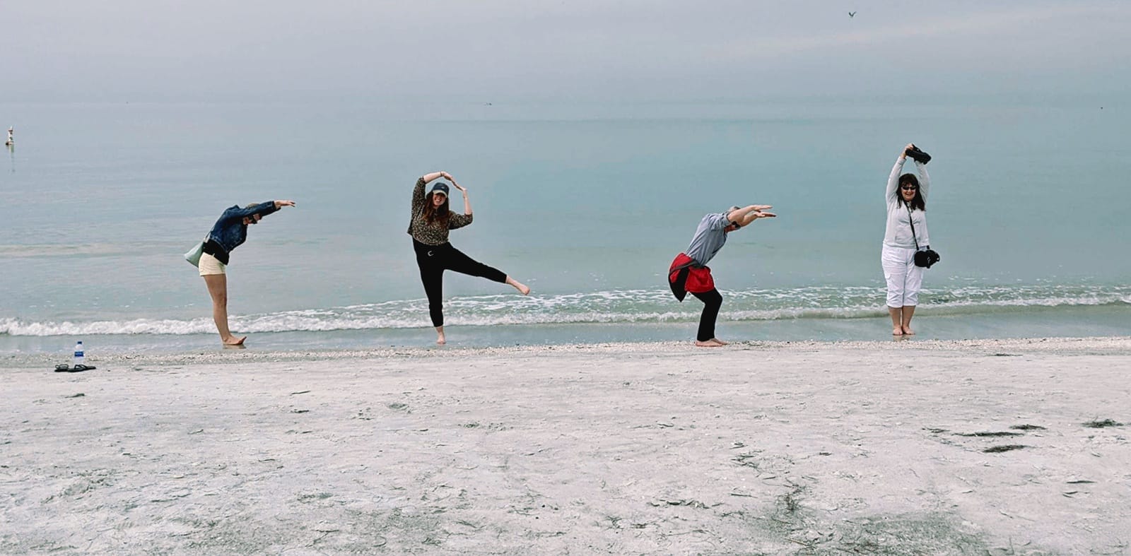 Team photo of Katie Hodgins, Lauren Sinclair, Robert McCoy, and Lori Vogelaar on a beach.