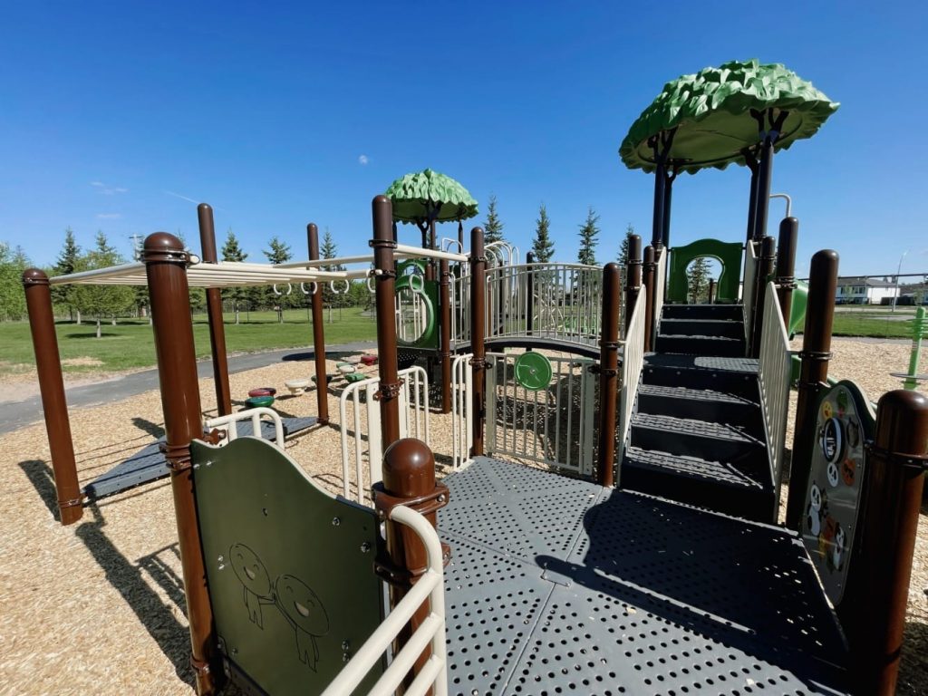 Memorial Park-7 Memorial Park in Gibbons, AB with Simon Says Panel, Silly Face Panel, Steering Wheel, Challenge Ladder, Ring Trek, and Deck to Deck Steps.