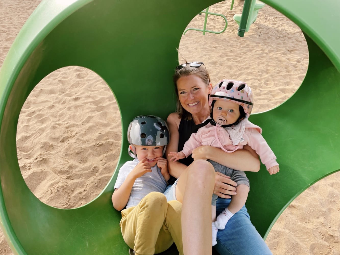 Katie Hodgins sitting in a Wobble Sphere with her two children, Grayson and Emmerson.
