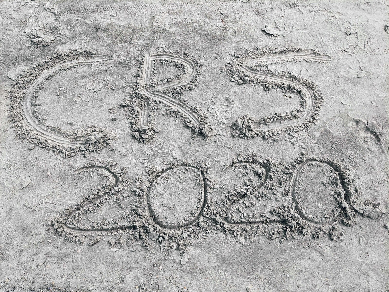 Beach with "CRS 2020" written in the sand.