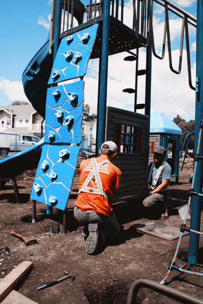 Two members of CRS's installation team installing a Village Window Panel.