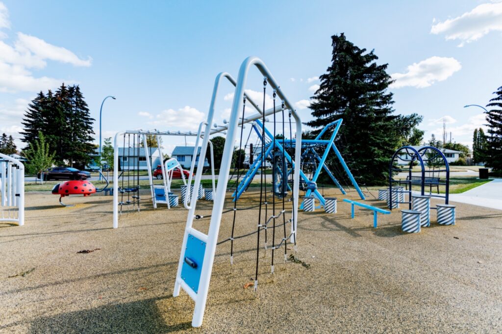 Albert G. Nickel Park-8 Close up view of Chaos Climber, Scarlet the Ladybug Spring Rider, Culvert Climbers, Wiggly Worm Climber, Balance Beam, and Grand Strand.