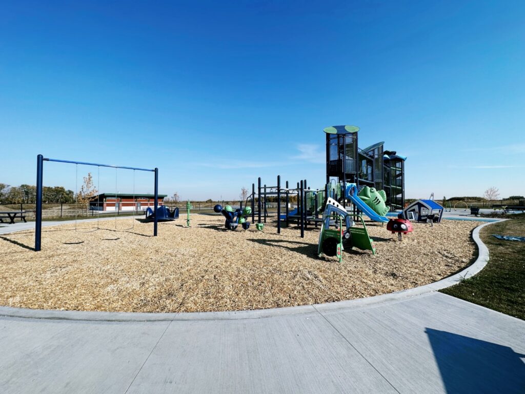 Pogadl Park-9 Pogadl Park in Sylvan Lake, AB with MaxPlay Swing Set, Tot Builders Truck, Scarlet the Ladybug Spring Rider, JAX Pack, Bongo Steps, Stand n Spin, and Revolution Inclusive Spinner.