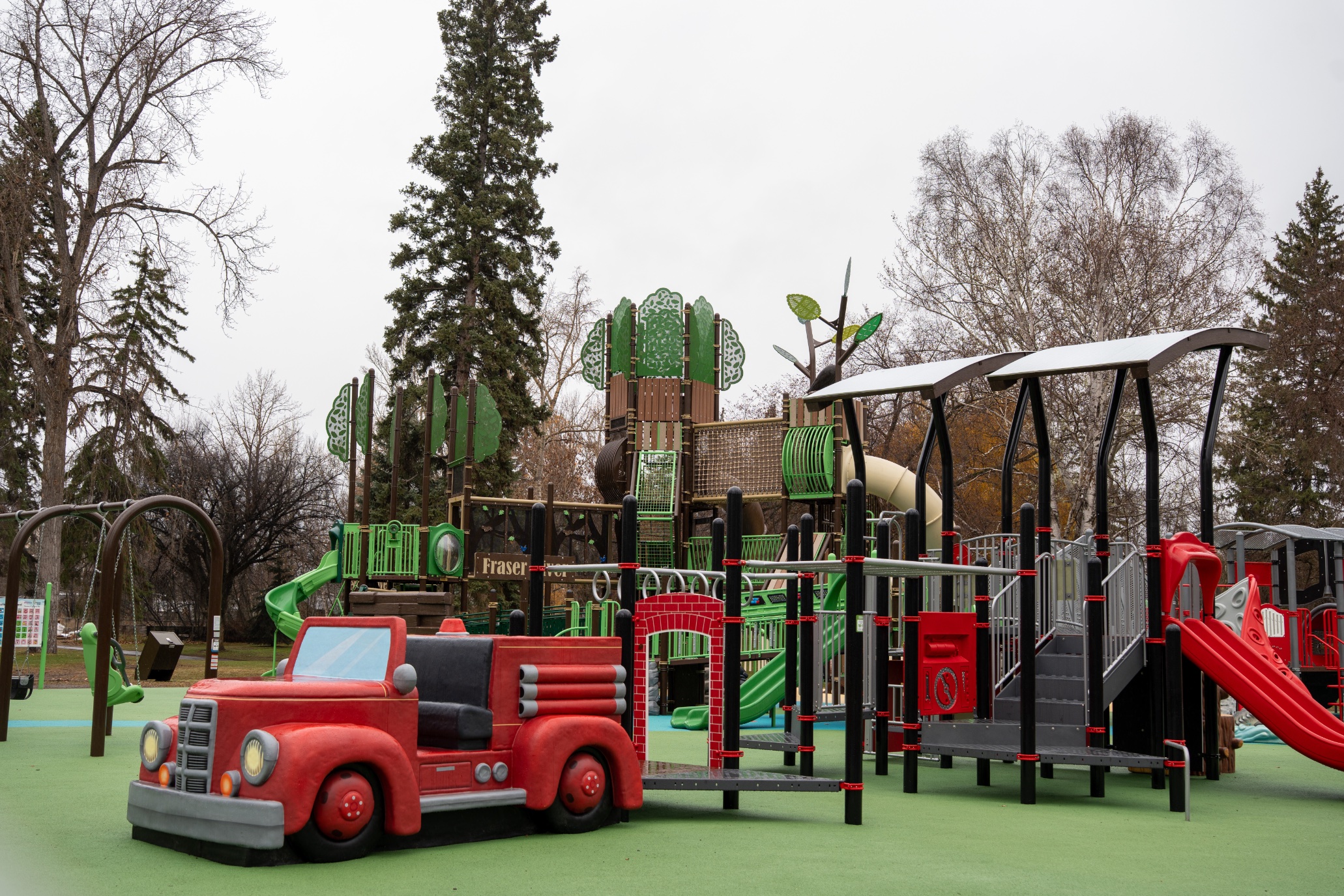 Fire truck play sculpture and tree tower at Lheidli T'enneh Memorial Park in Prince George, BC.