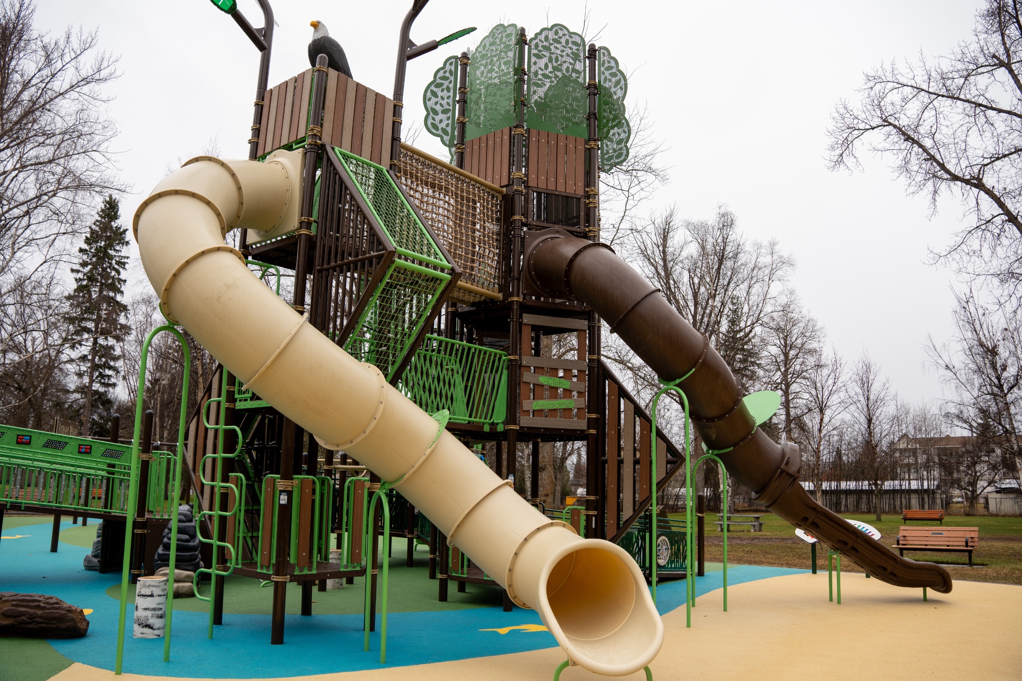 Beige and brown tube slides with an eagle on top at Lheidli T'enneh Memorial Park in Prince George, BC.
