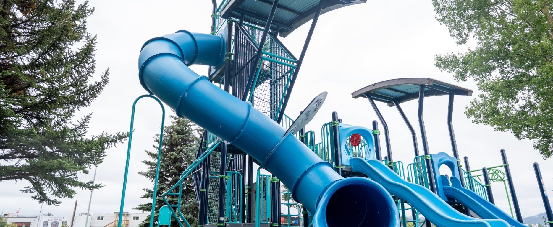 Blue tube slide and two wave slides on the play tower at Steelhead Park in Houston, BC.