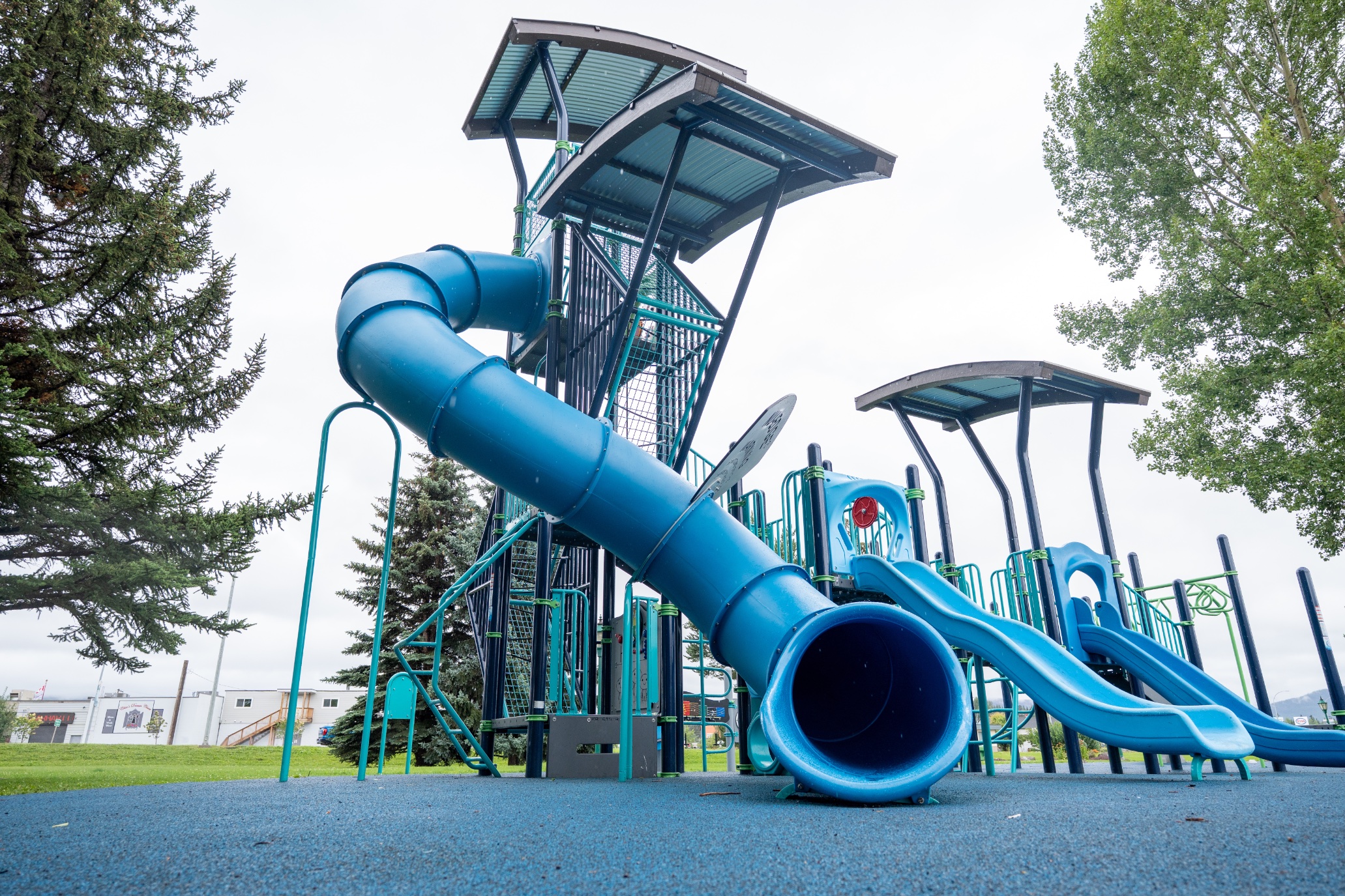 Blue tube slide and two wave slides on the play tower at Steelhead Park in Houston, BC.