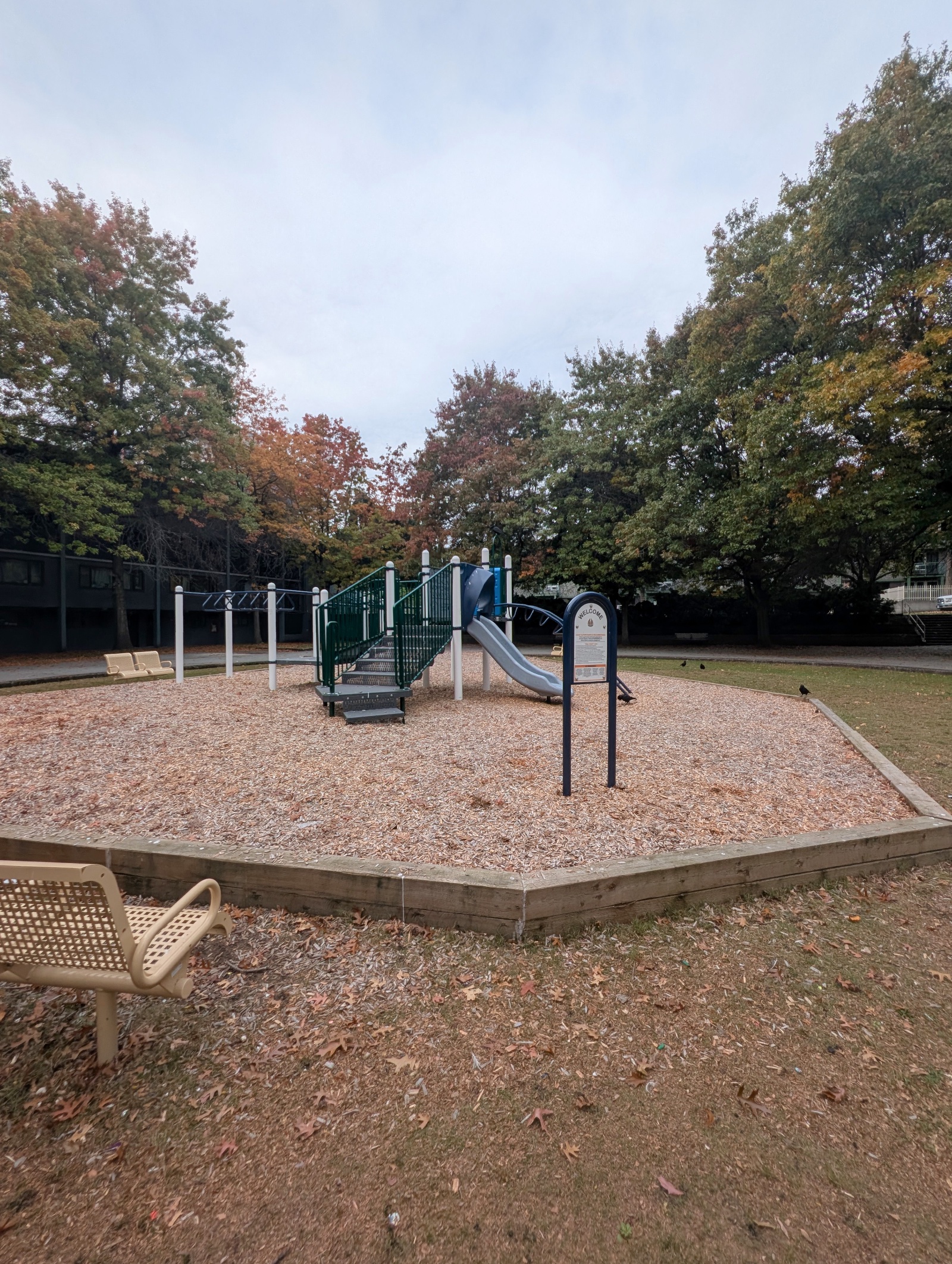 Autumn view of MacLean Park in Vancouver, BC, showing the slide, welcome sign and monkey bars.