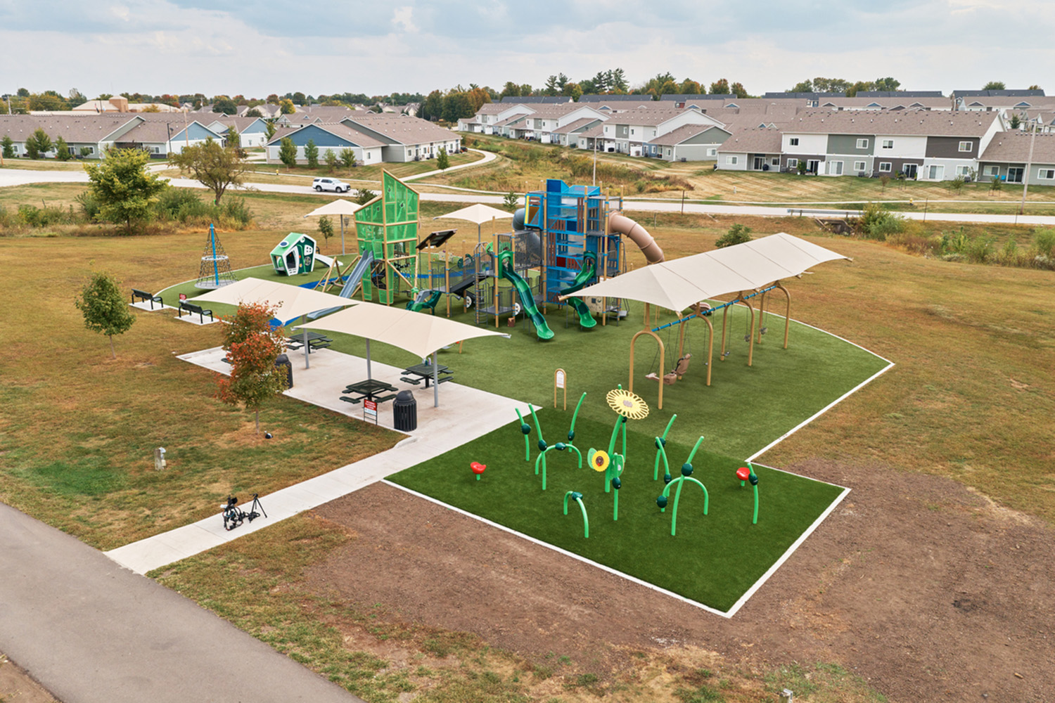 Aerial view of a custom-themed playground with an interactive game, shaped by a thoughtful playground planning checklist.